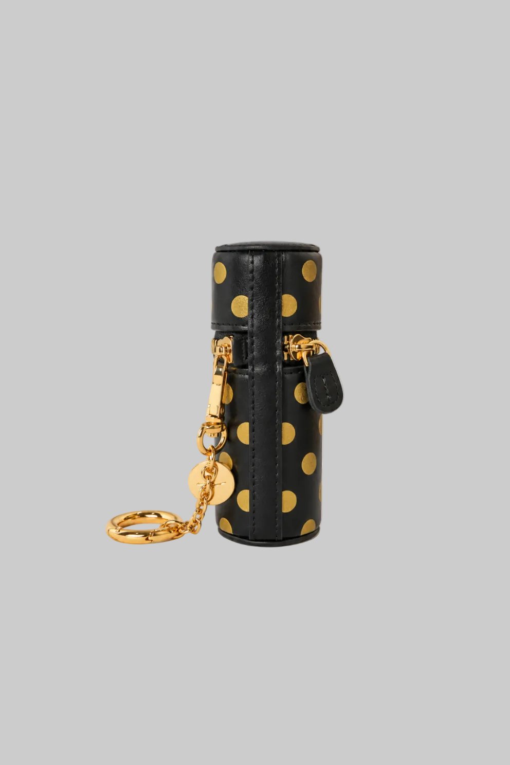 Black cylindrical lipstick holder keyring with teal polka dots, a detachable gold-tone keyring, and a magnetic closure on a white background.