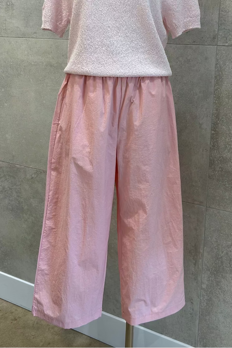 Pink semi-wide leg pants styled on mannequin at Dear Petite boutique