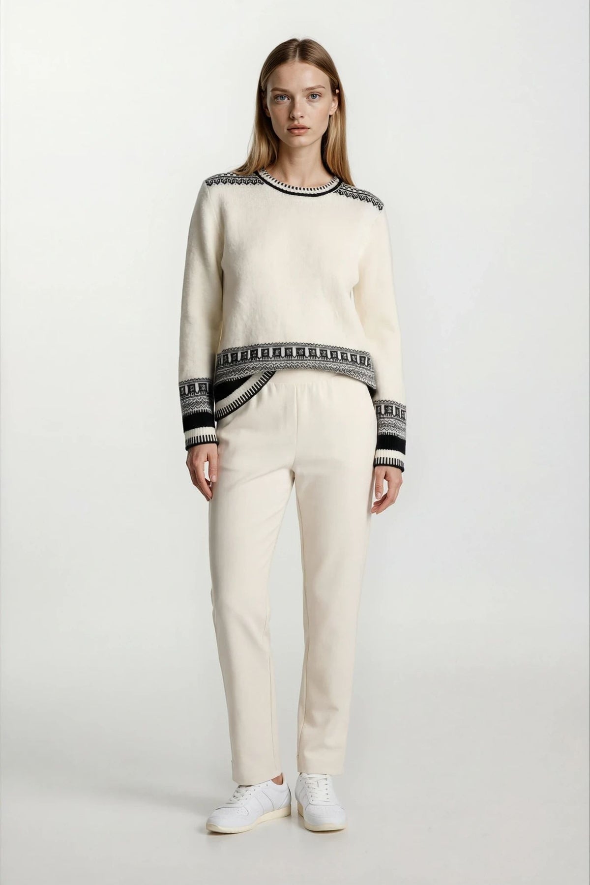 Model wearing cream petite fleece-lined straight-leg pants with a comfortable pull-on elastic waistband.