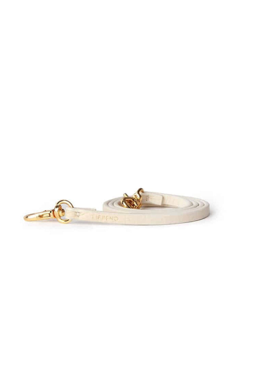 Ivory synthetic leather Fettuccine Strap with gold-tone hardware, a key ring, and a lobster clasp on a white background.