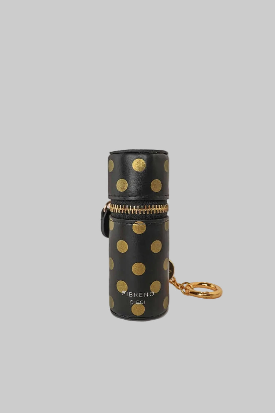 Black cylindrical lipstick holder keyring with teal polka dots, a detachable gold-tone keyring, and a magnetic closure on a white background.