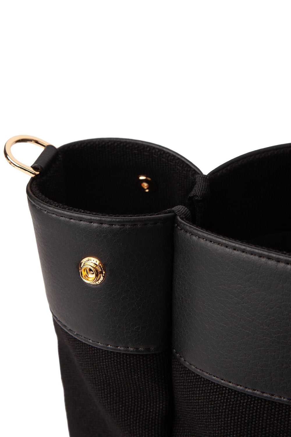 Detail of Black two-tone small tote bag with synthetic leather trim, gold-tone hardware, top handles, and an adjustable shoulder strap.